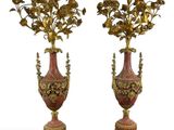 two vases with flowers on top of each other on a white surface