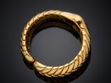 a close up of a gold ring on a black surface
