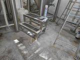 a room with a lot of metal tanks and ladders