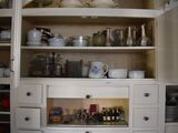 a cabinet with a lot of dishes and cups on it