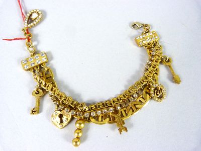 gold plated necklace with charms and a red string
