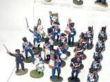 a lot of figurines that are on display on a table