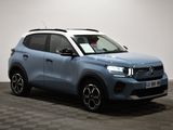 the blue suv is parked on a checkered floor in a room