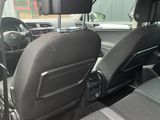 the interior of a car with the door open and the driver ' s seat down