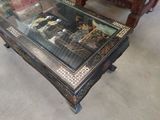 a glass table with a picture on it in the middle of a room