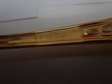 a gold spoon that is sitting on a table