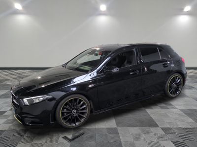 the black mercedes wagon is parked on a checkered tile floor
