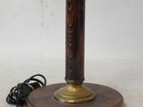 an image of a table lamp with a wooden base and a cord plugged into the base