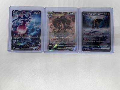 three different pokemon cards in plastic cases on a white surface