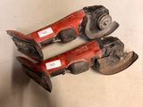 pair of old red and black shoes with tags on them sitting on a white surface