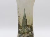 a picture of a glass vase with a church in the background