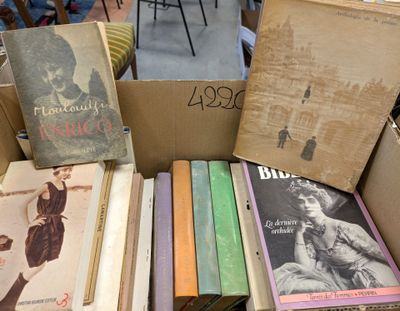 boxes of books are stacked on top of each other in a room