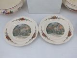 two plates with a picture of a town on them