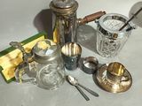 a lot of silver and glass items sitting on a table