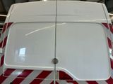 a red and white van parked inside of a building