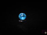 an image of a blue glass ball in the dark