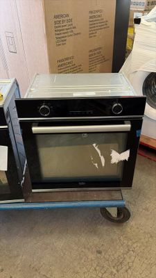 two ovens sitting on a cart in a room