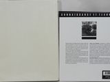 the back of a white box with a black and white picture of a man
