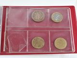 a red box with coins in it on a table