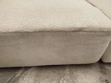 a close up of a couch with a pillow on top of it