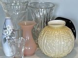 many different vases and glasses on a shelf
