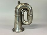a silver trumpet that is sitting on a table