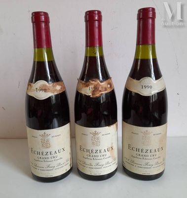 three bottles of red wine are lined up on a table