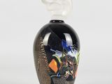 an image of a black vase with a bird on top of it