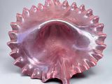 pink glass shell shaped dish on a white surface