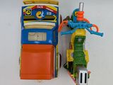 a toy train and a toy car on a white surface