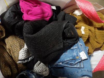 a box full of clothes that is sitting on the floor