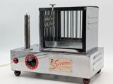 a silver machine with a red handle on a white surface