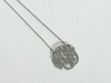 a close up of a necklace on a white surface with a white background