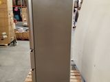 a refrigerator that is sitting on a pallet in a warehouse