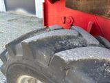 a large tire on the side of a red truck