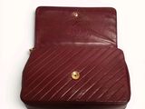 a red purse that is sitting on a white surface