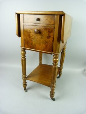 a small wooden table with a drawer on top of it