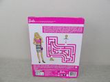barbie doll in a box with a pink dress and shoes