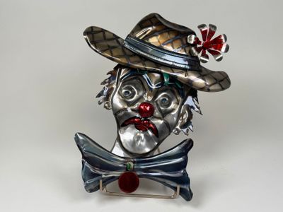 a statue of a clown wearing a hat and a bow tie