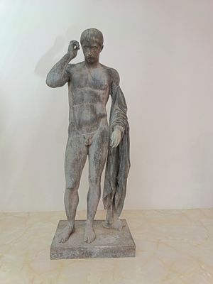 statue of a man holding a fish in his right hand