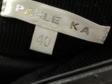 a label on the back of a black jacket