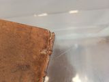 an old book inside of a clear plastic bag