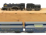two toy trains that are sitting on top of a wooden box