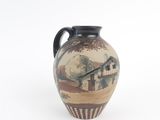 a vase with a painting on it on a white surface