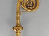a gold clock that is attached to a pole