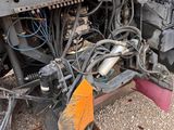 a close up of a truck with a broom attached to it