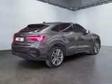 the rear end of a grey audi qx parked in a garage