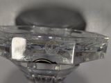 a glass candle holder with a gold ring on it