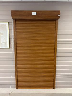 a wooden door that is open on the side of a building
