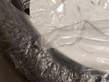 a cake in a pan covered in plastic wrap